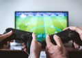 two people playing a video game after setting up a gaming room in your new home
