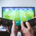 two people playing a video game after setting up a gaming room in your new home