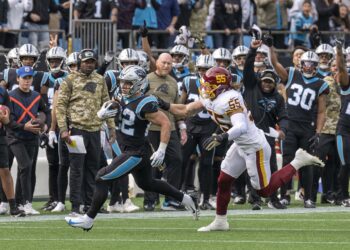 Carolina Panthers ball carrier breaks away from a Washington defender during an NFL game