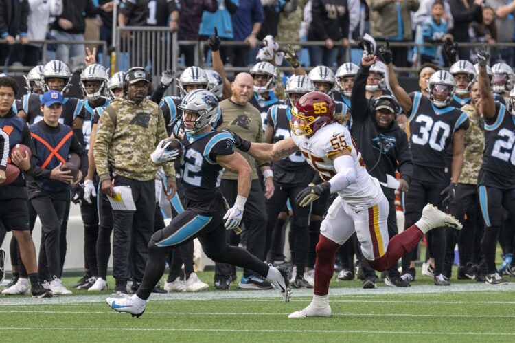 Carolina Panthers ball carrier breaks away from a Washington defender during an NFL game